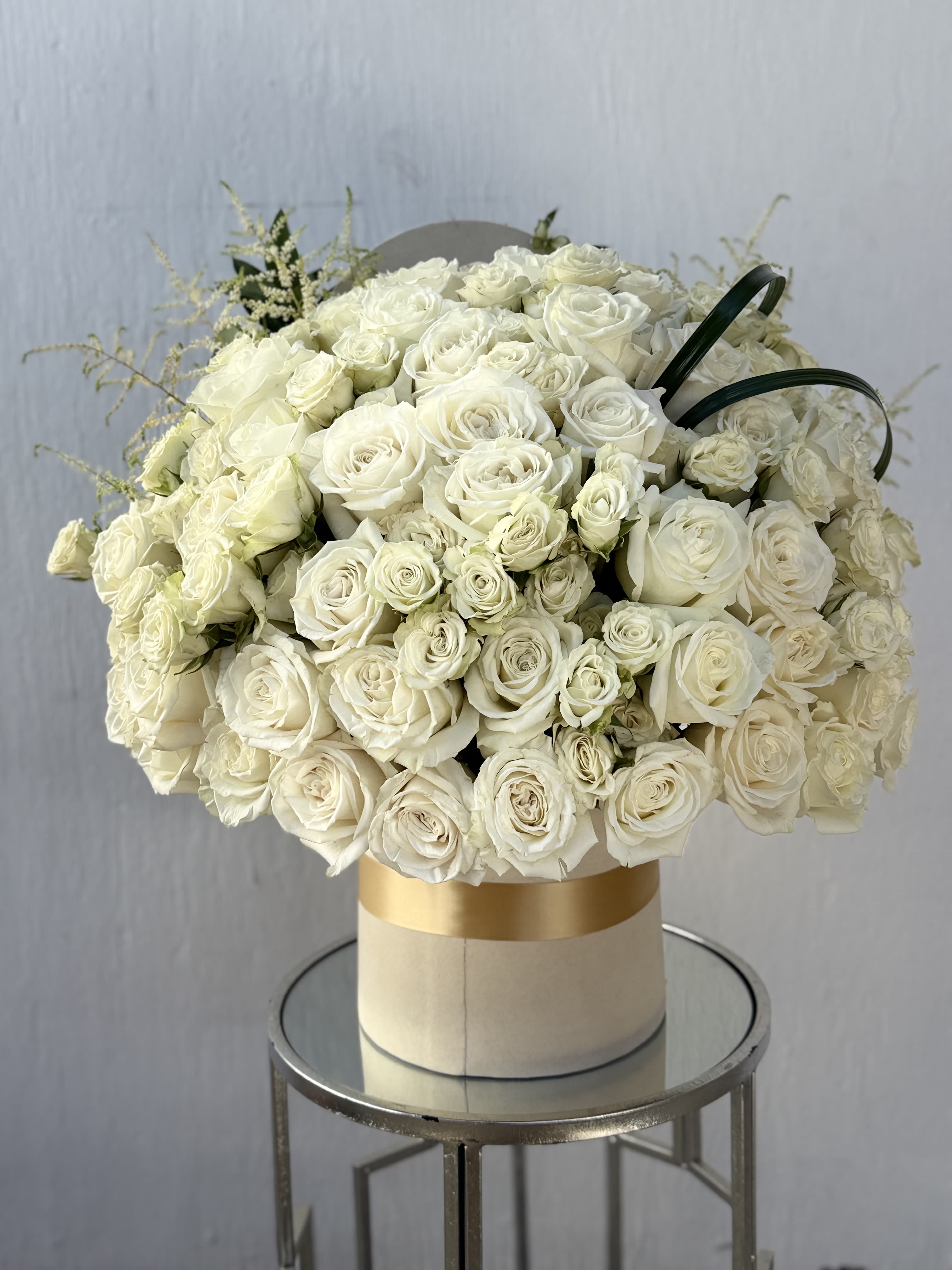 White Roses arrangement - A luxurious arrangement featuring 50 premium white roses paired with delicate white spray roses, artfully designed in an elegant velvet rose box. This timeless piece showcases purity and sophistication, with each rose carefully selected for its freshness and beauty. Perfect for weddings, proposals, anniversaries, or any moment that calls for a touch of classic elegance.