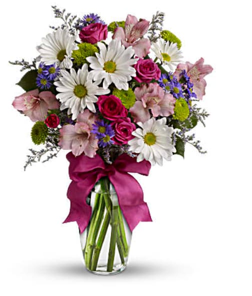 Bouquet of daisies, roses, and pink lilies in a glass vase