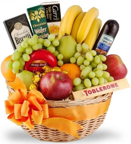 Fruit basket with bananas, grapes, apples, pears, and chocolates