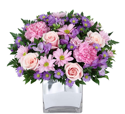Pink and purple mixed bouquet in a clear glass vase