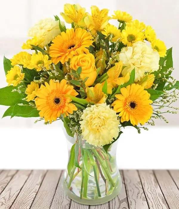 Golden Sunshine - This bright and bold bouquet is full of the most beautiful yellow stems, including a single yellow rose, long-lasting alstroemeria, germini, carnations and seasonal foliage. 