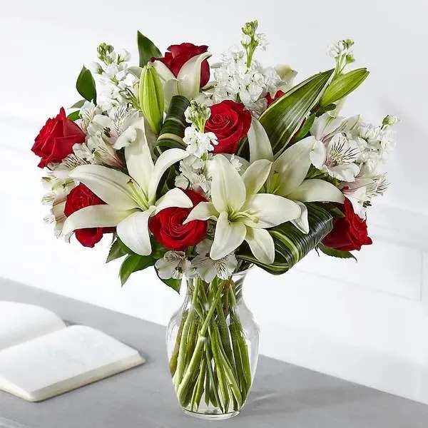 Loving Respect Bouquet - Elegantly crafted with a stunning mix of red and white blooms, our Loving Respect Bouquet reminds those you care about that you are thinking of them. Our talented designers arrange roses and lilies together to convey your comfort and love