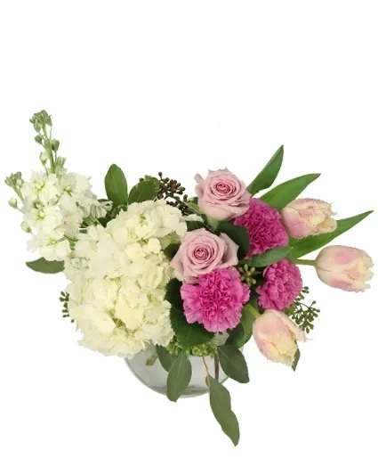Pink roses and carnations with white hydrangeas in a glass vase