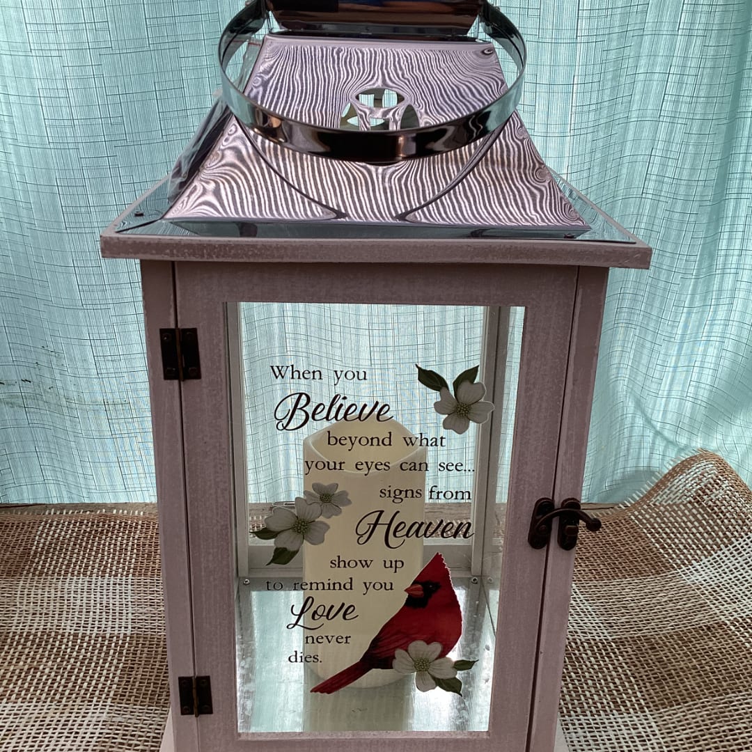 Decorative lantern with a memorial quote and cardinal graphic