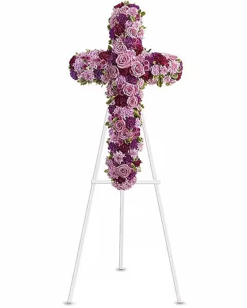 Deepest Faith - Easel - "Pride, dignity, admiration and faith are on beautiful display in this moving sympathy arrangement. It's a meaningful way to deliver your heartfelt message. Beautiful flowers such as lavender roses, carnations and cushion spray chrysanthemums along with fuchsia and purple carnations and button spray chrysanthemums create a dazzling cross that is full of hope and devotion."