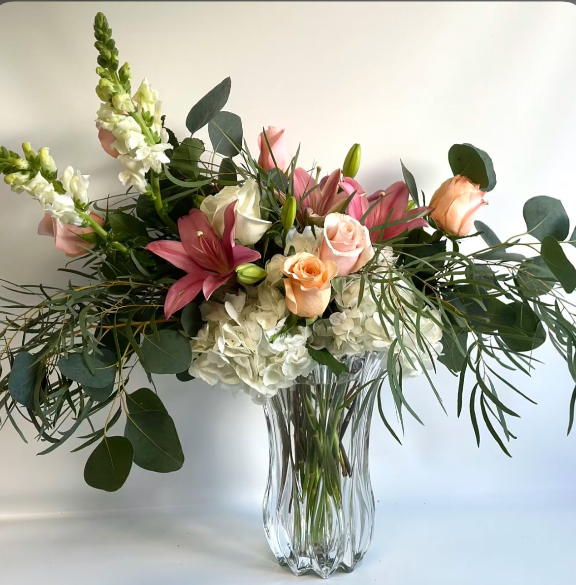 Wild Willow - Natural beauty meets untamed charm in Wild Willow. This garden-inspired arrangement features graceful willow accents paired with a lush mix of fresh seasonal blooms, creating movement, texture, and a touch of wild elegance. Soft petals and airy greenery weave together for a design that feels effortless—like flowers gathered from a blooming meadow.  Organic, romantic, and full of life, Wild Willow brings a relaxed yet striking presence to any space. Perfect for celebrating, comforting, or simply adding a bit of wild beauty to the day.