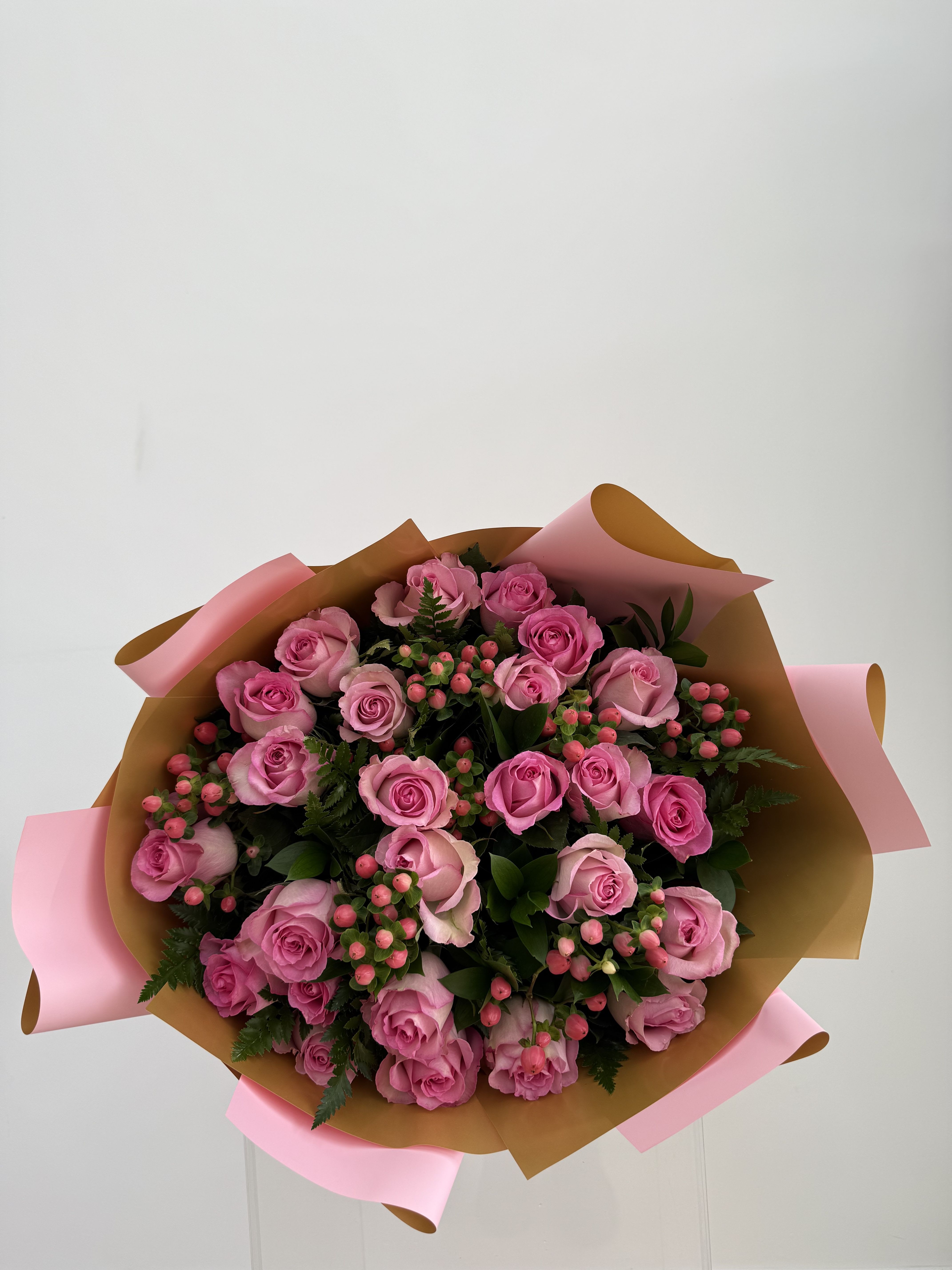 Bouquet of pink roses wrapped in brown and pink paper