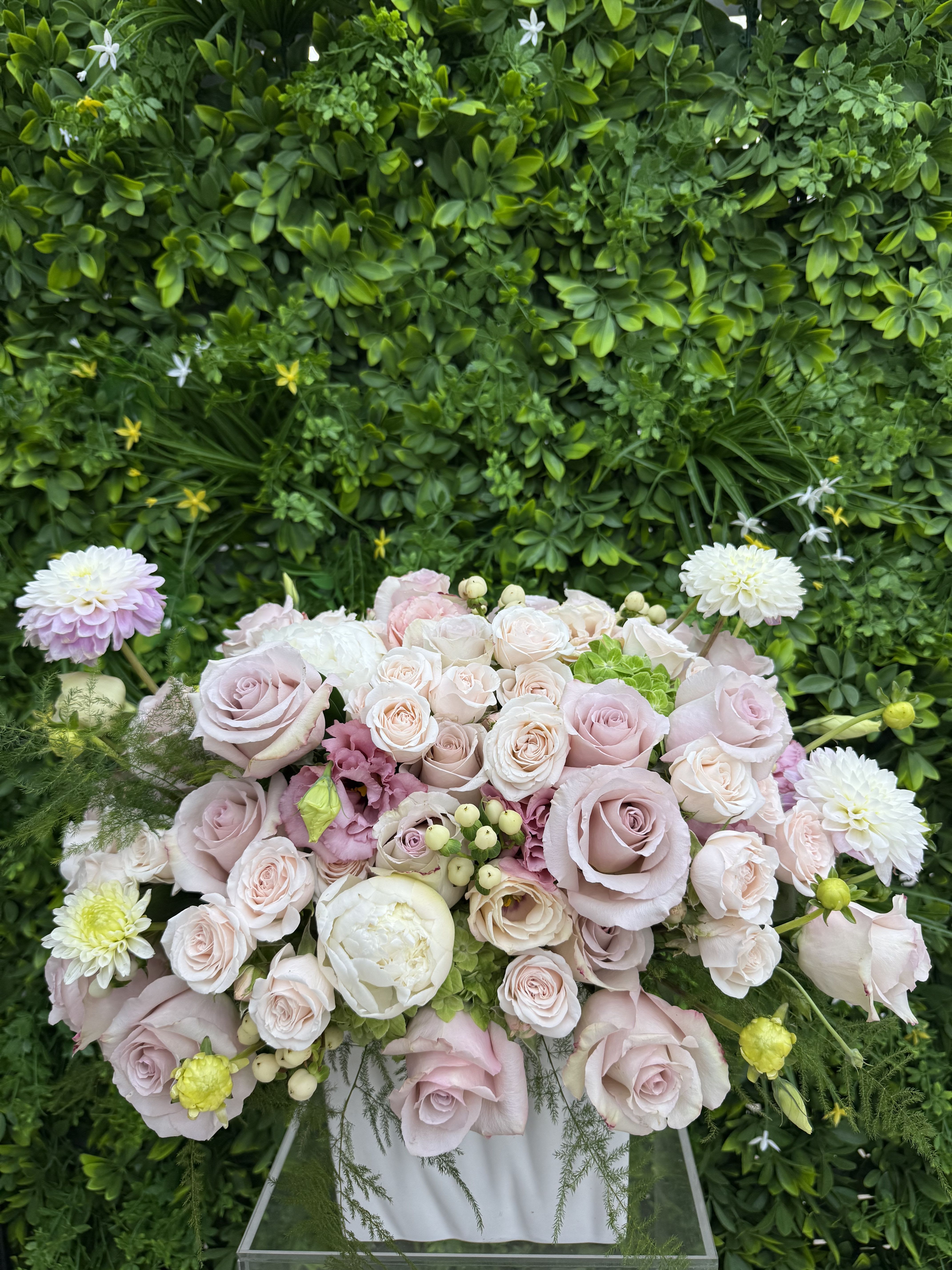 Pastel rose bouquet with white and pink blooms in a clear stand