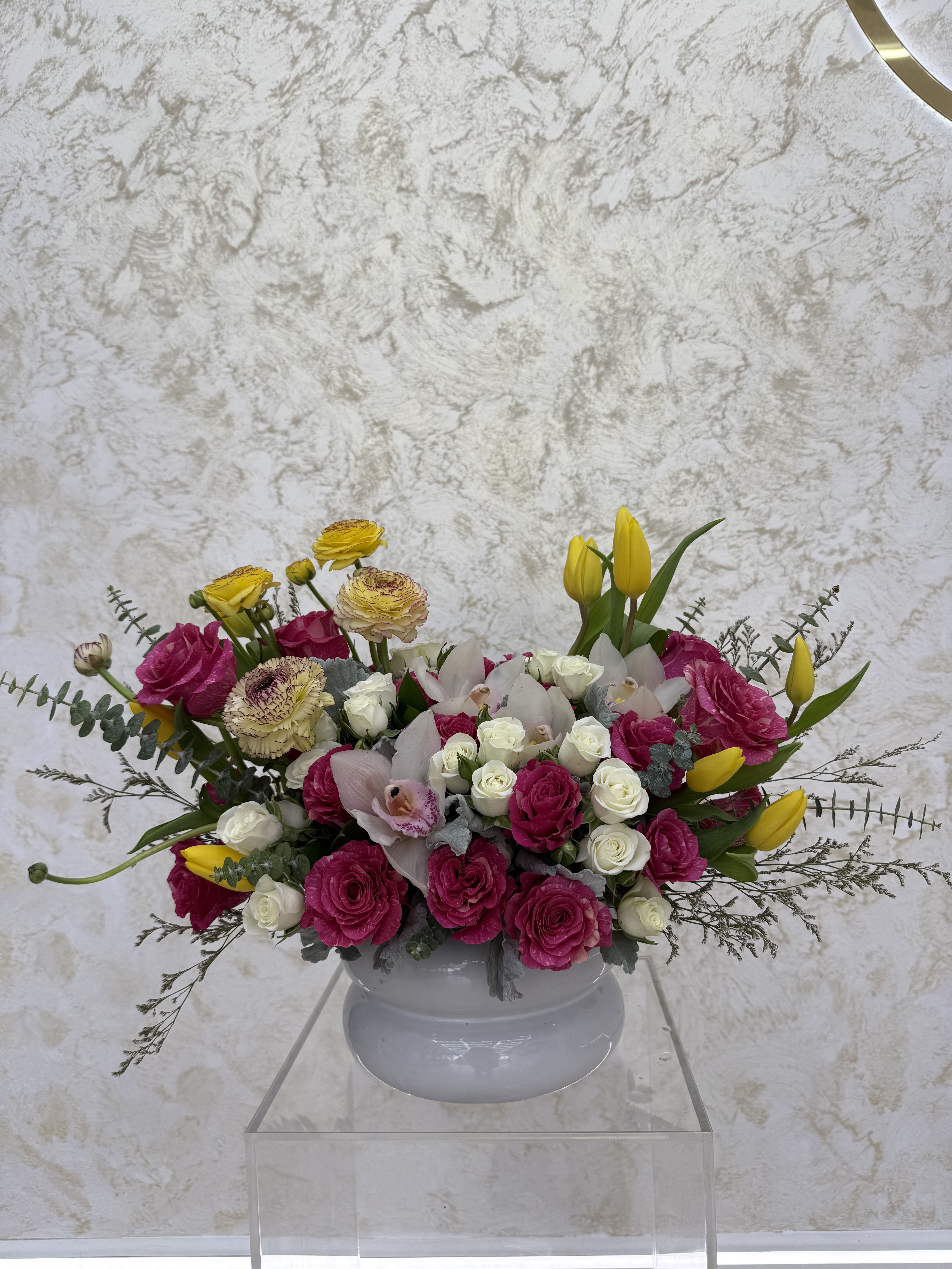 Mixed bouquet of pink and white flowers in a white vase
