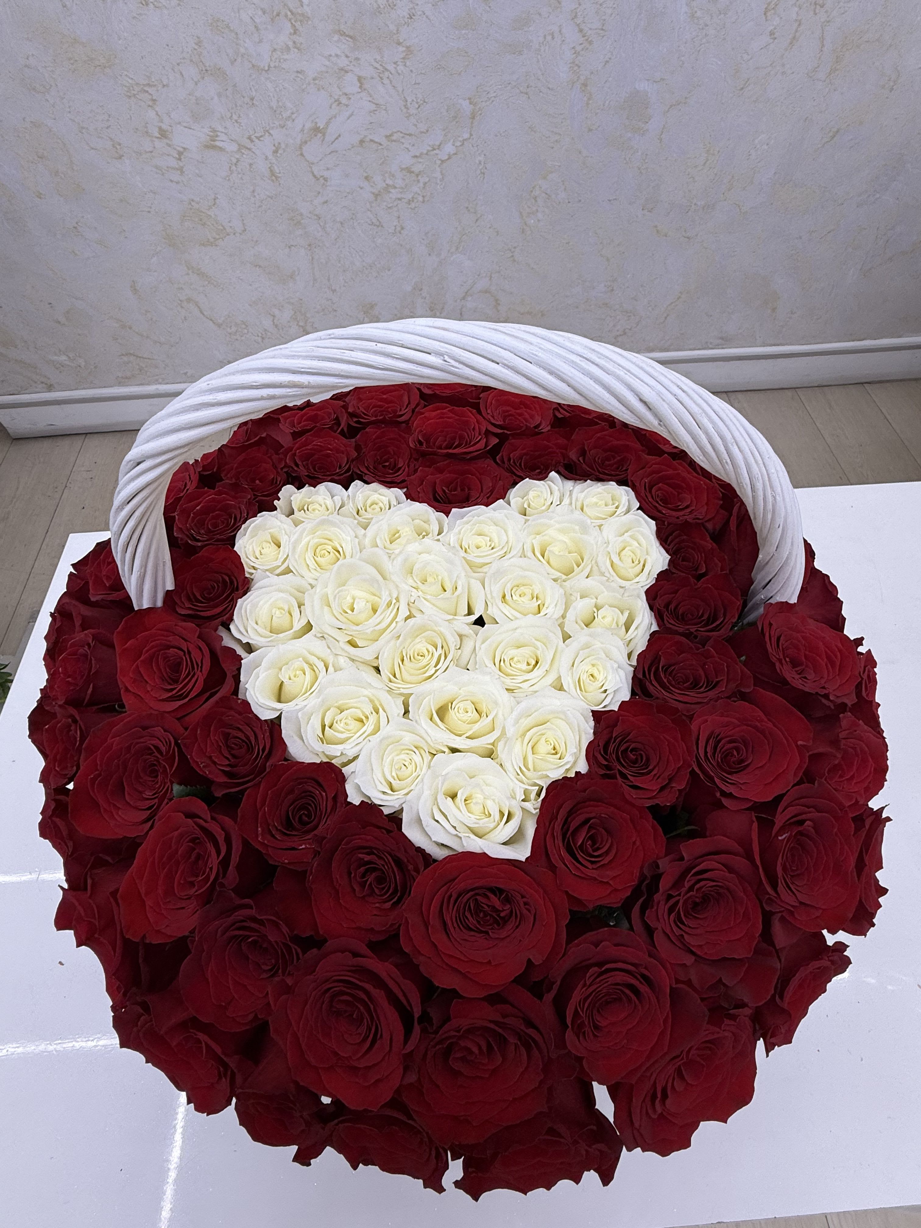 Heart-shaped basket filled with red and white roses