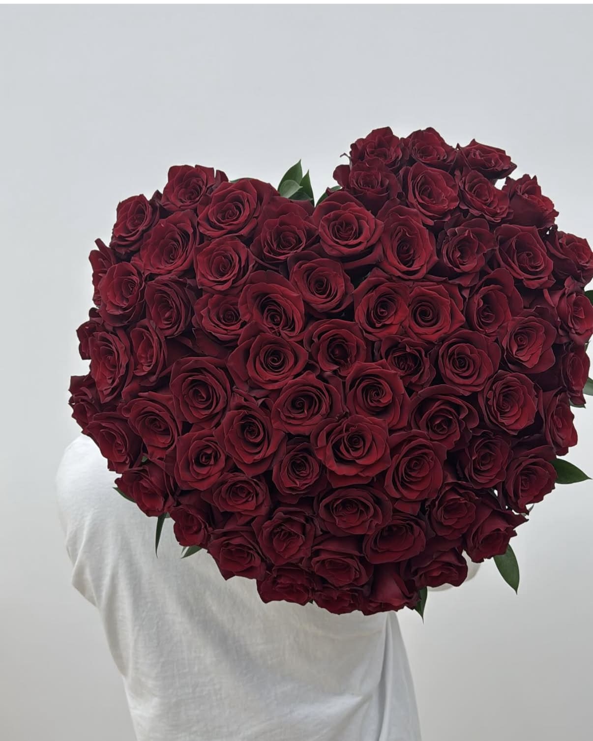 Large heart-shaped bouquet of deep red roses