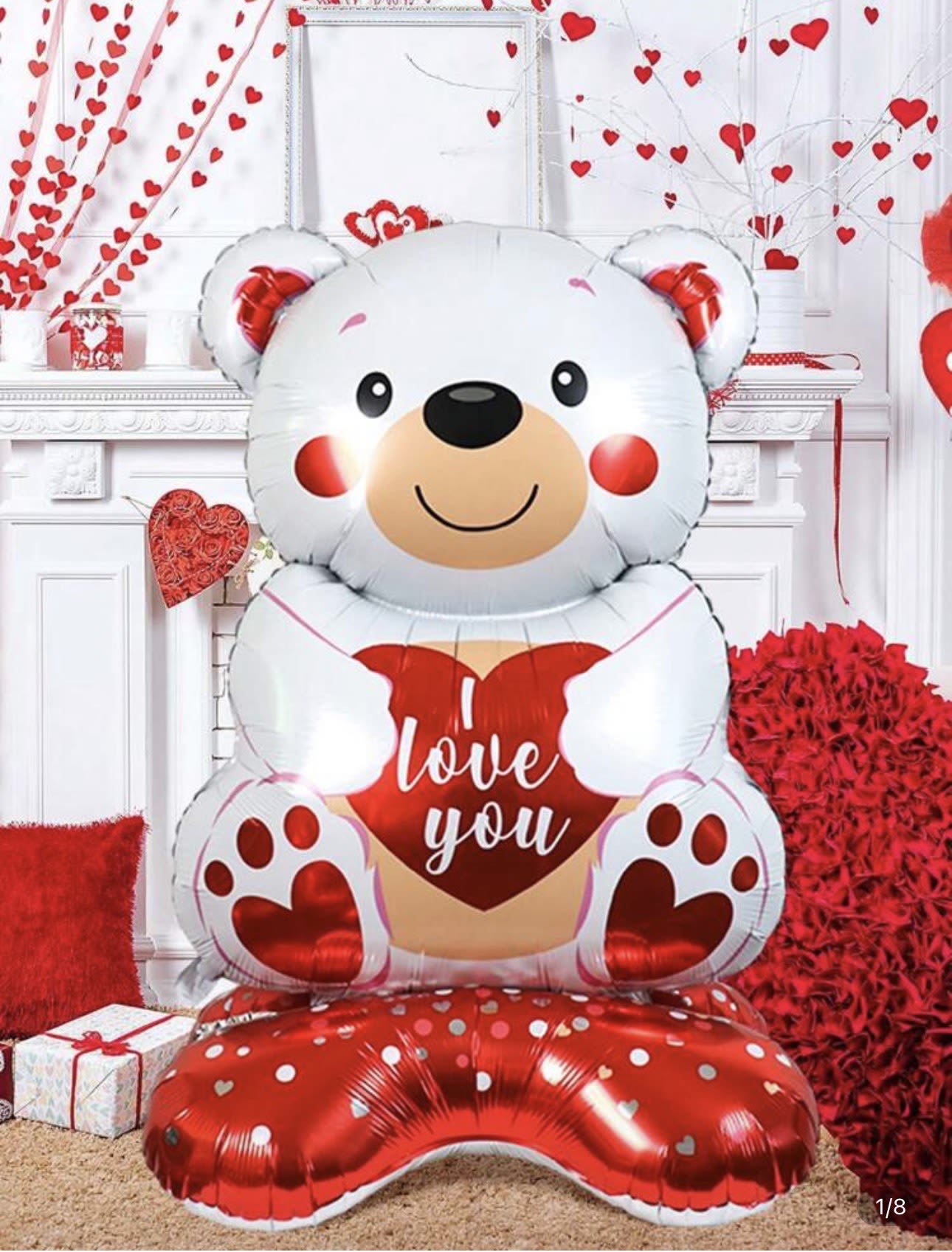 Large teddy bear balloon holding a heart with "love you" text