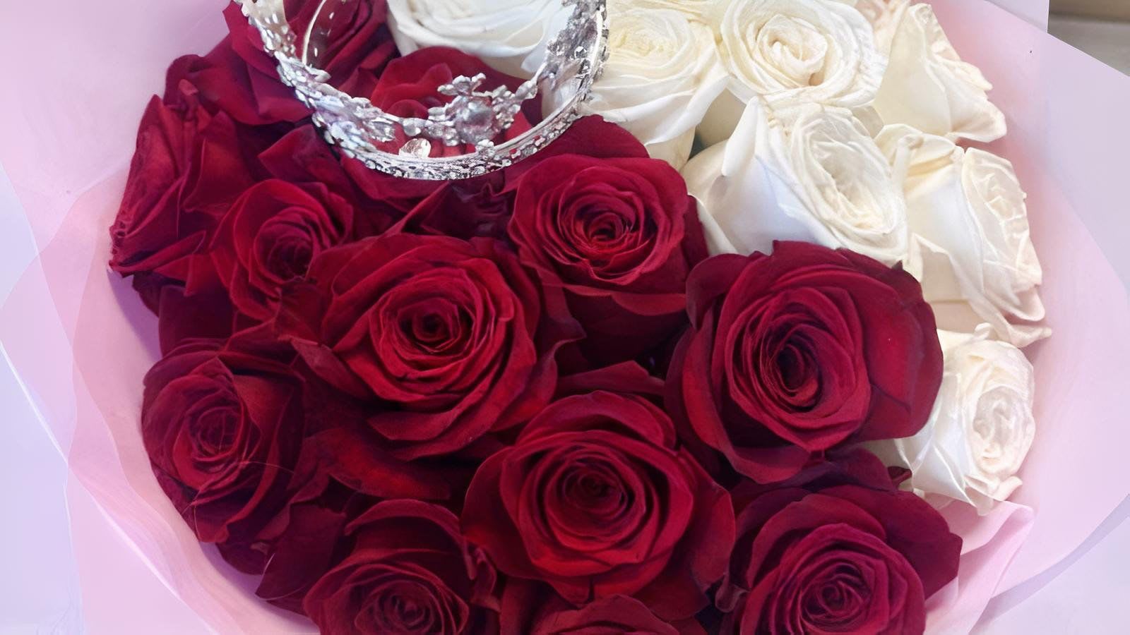 Bouquet of red and white roses with a jeweled crown