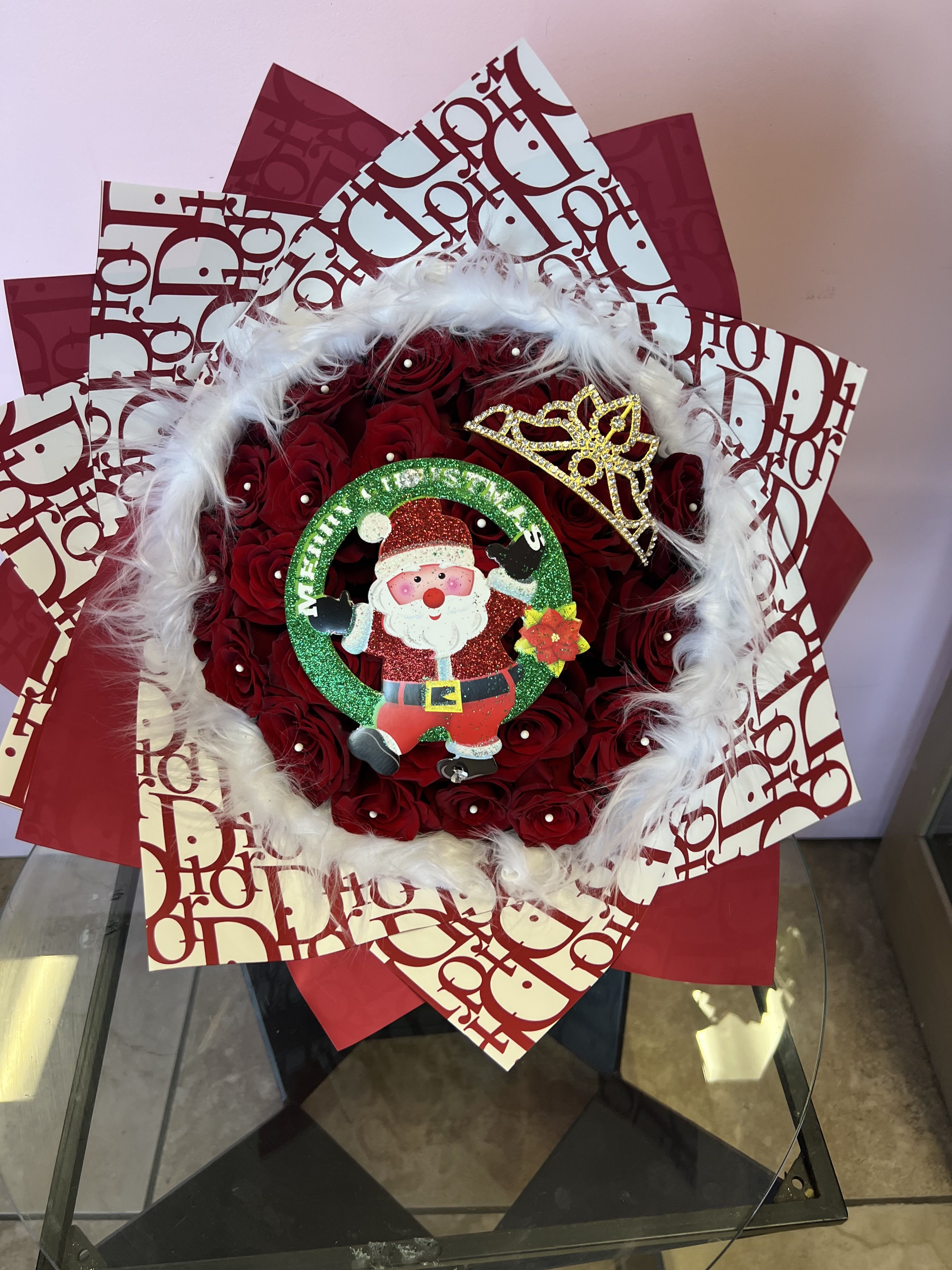 Red rose bouquet with Santa decoration and white feather trim