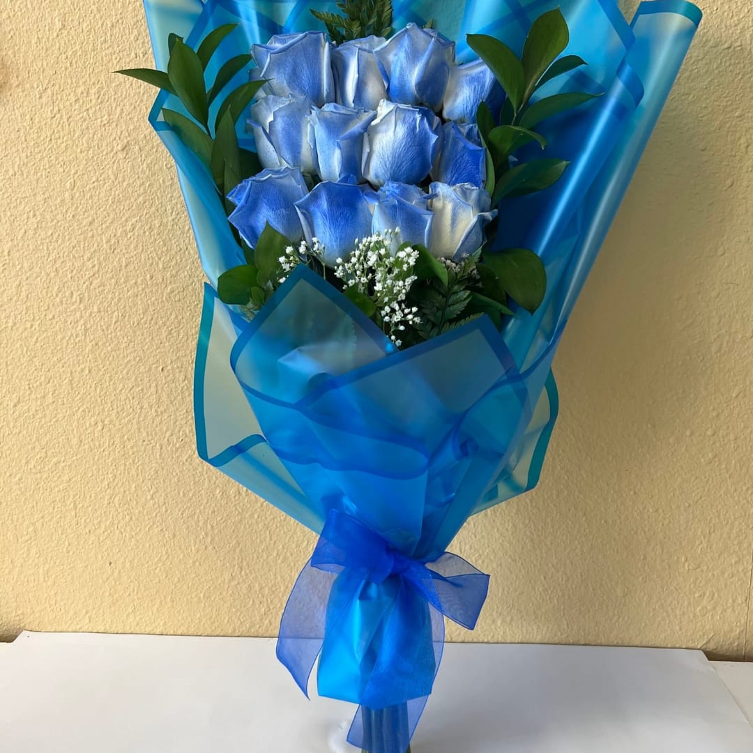 Blue roses wrapped in bright blue paper with a ribbon