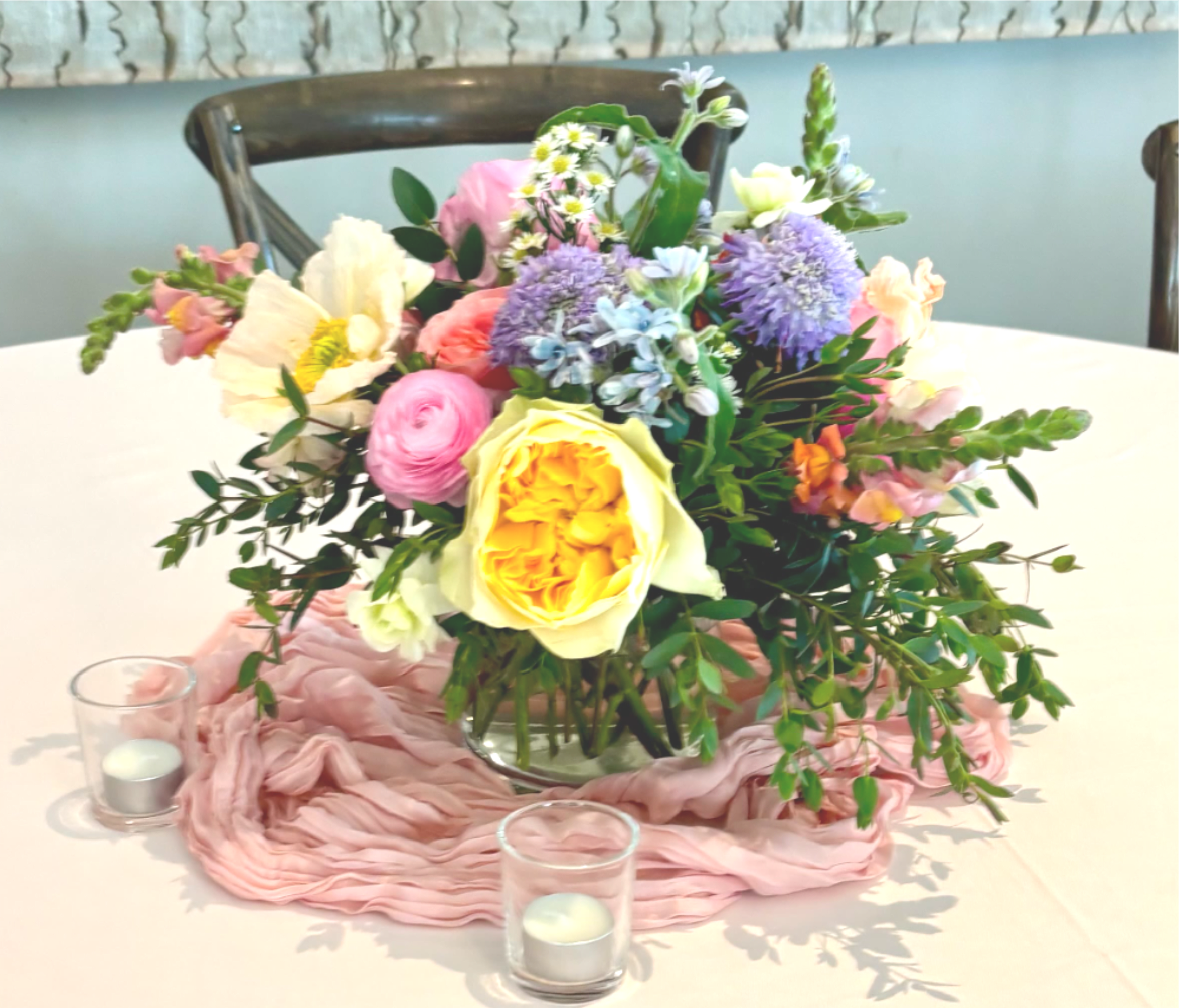 Bespoke Master's Tablescape - Cylinder Vase (The Standard) The Vibe: Charming, intimate, and delicate. A small beautiful collection of focal blooms nestled in light greenery, styled in a classic cylinder vase.  Compote (The Classic) The Vibe: Lush, romantic, and beautifully balanced. Our most popular table arrangement. This low-profile design is styled in a footed compote bowl, featuring a full, rounded mix of premium focal flowers, rich textures, and cascading foliage. It offers a stunning visual impact while remaining low enough for easy across-the-table conversation.  Tall Arrangement (The Statement) The Vibe: Grand, luxurious, and dramatic. Elevate your reception with a high-impact, elevated design. Placed atop a sleek riser or clear pedestal, this oversized arrangement bursts with premium blooms and sprawling greenery. It creates instant visual drama, filling high-ceiling spaces with pure luxury while leaving the tabletop open for guests. Stands are available for rental. Delivery &amp; Install extra. 