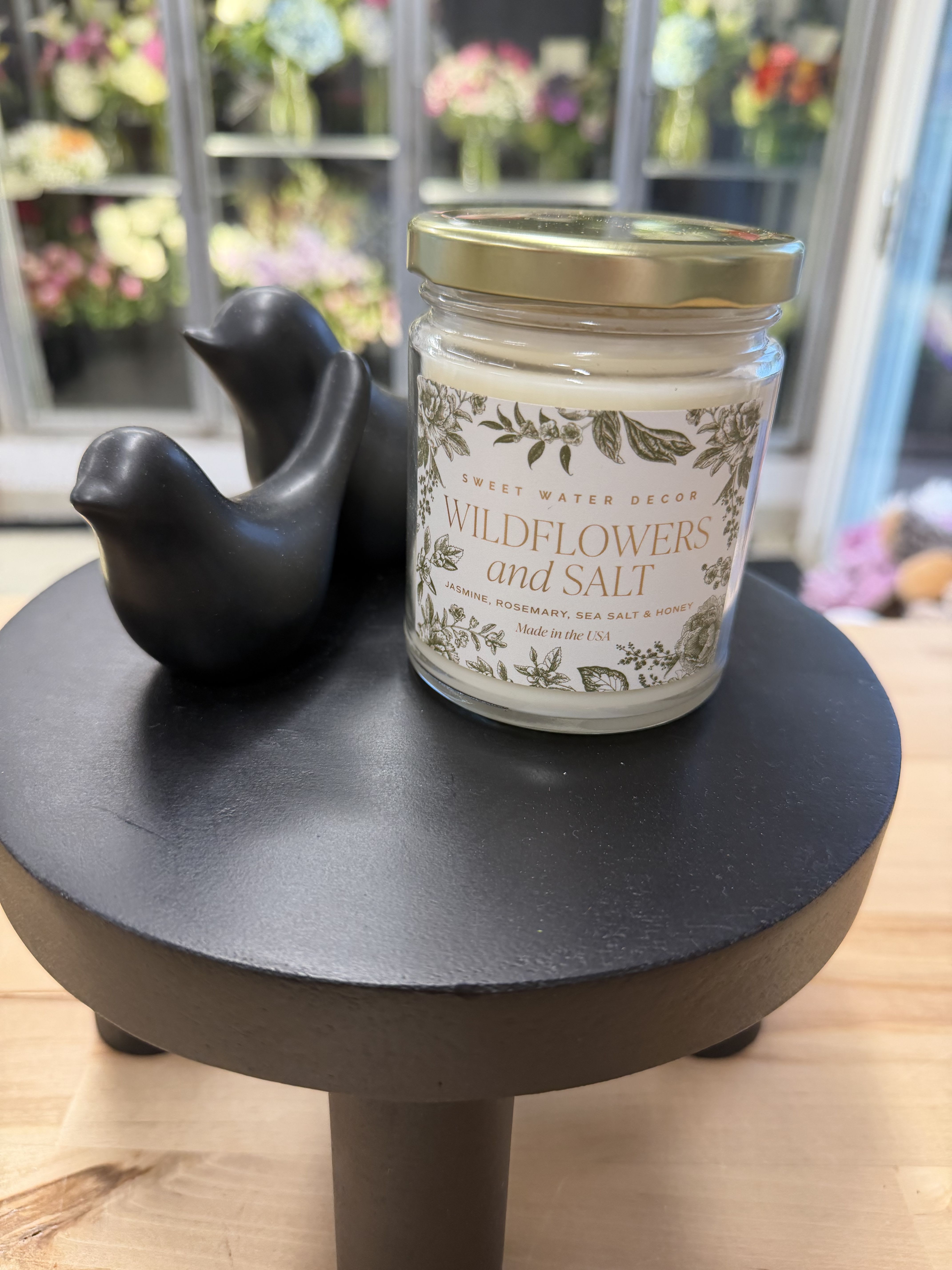 Candle - Wildflowers &amp; Salt - Bring the warmth and beauty of nature indoors with our Wildflowers and Salt soy candle. The natural floral scents of Jasmine, Lily, Geranium, and Violet combine to create a sweet, gentle scent that is pure perfection. Blended with grounding leafy greens, salt, and amber scent notes, this complex floral candle will have your place smelling fresh and fragrant like a stroll through a garden or field of wildflowers.