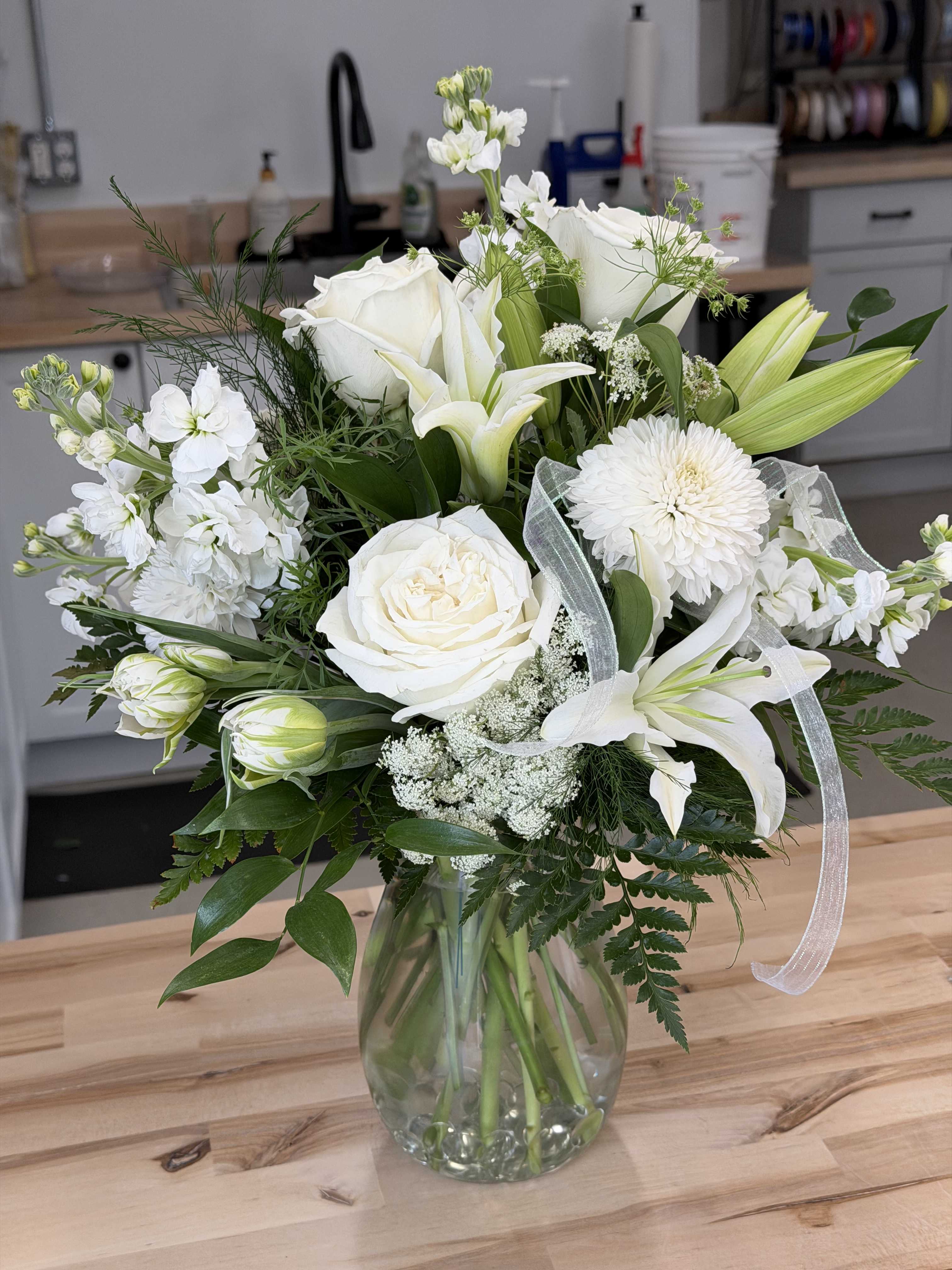 White floral bouquet in a clear glass vase