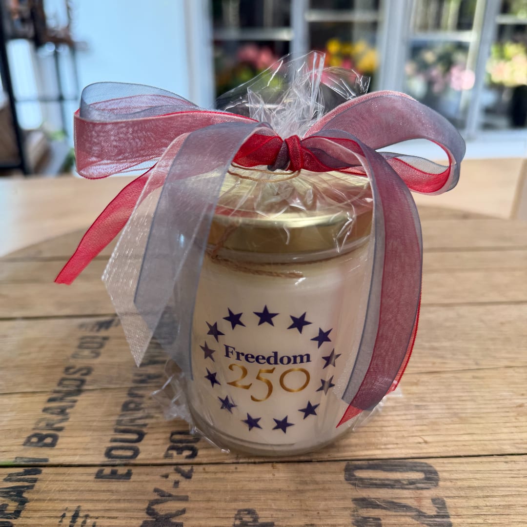 Gift jar wrapped with a red and blue ribbon bow