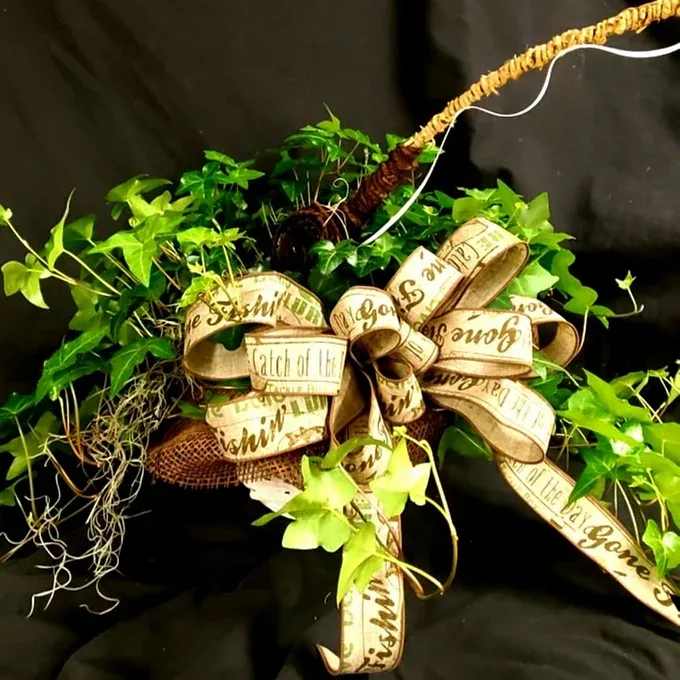 Green ivy wreath with a large decorative ribbon bow