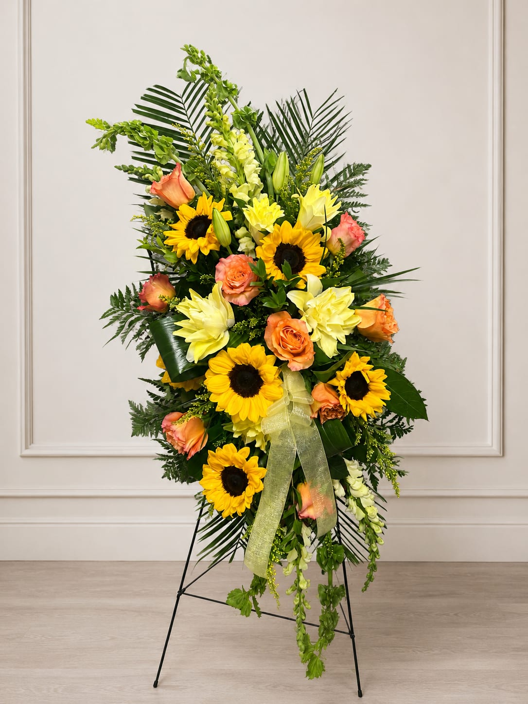SP15 Standing Spray - A mix of Bells of Ireland, mini sunflowers, lilies, roses, snap dragons, greens.   Banner - $15.00 + extra  Substitutions may apply due to flower availability