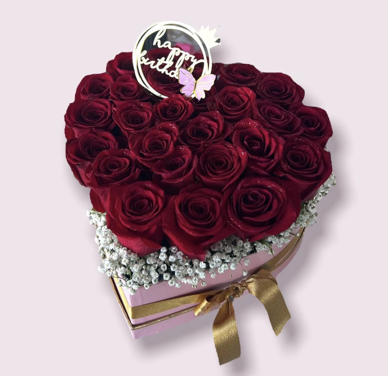 Heart-shaped box of red roses with a birthday topper and gold ribbon