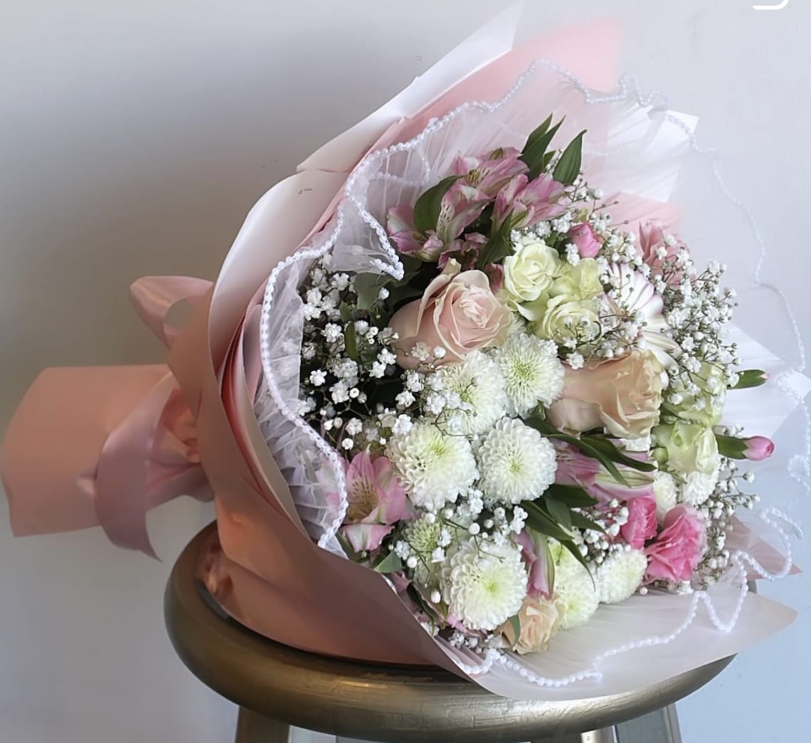 Pink and white mixed bouquet wrapped in pastel paper and lace