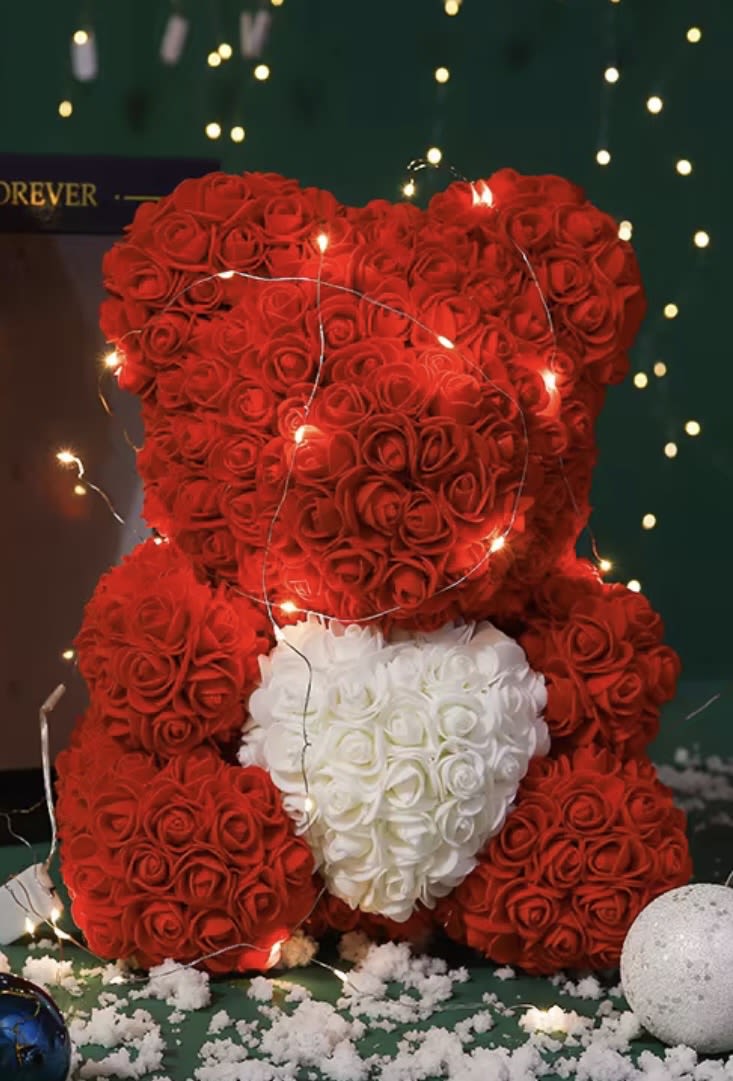 Red rose teddy bear holding a white rose heart
