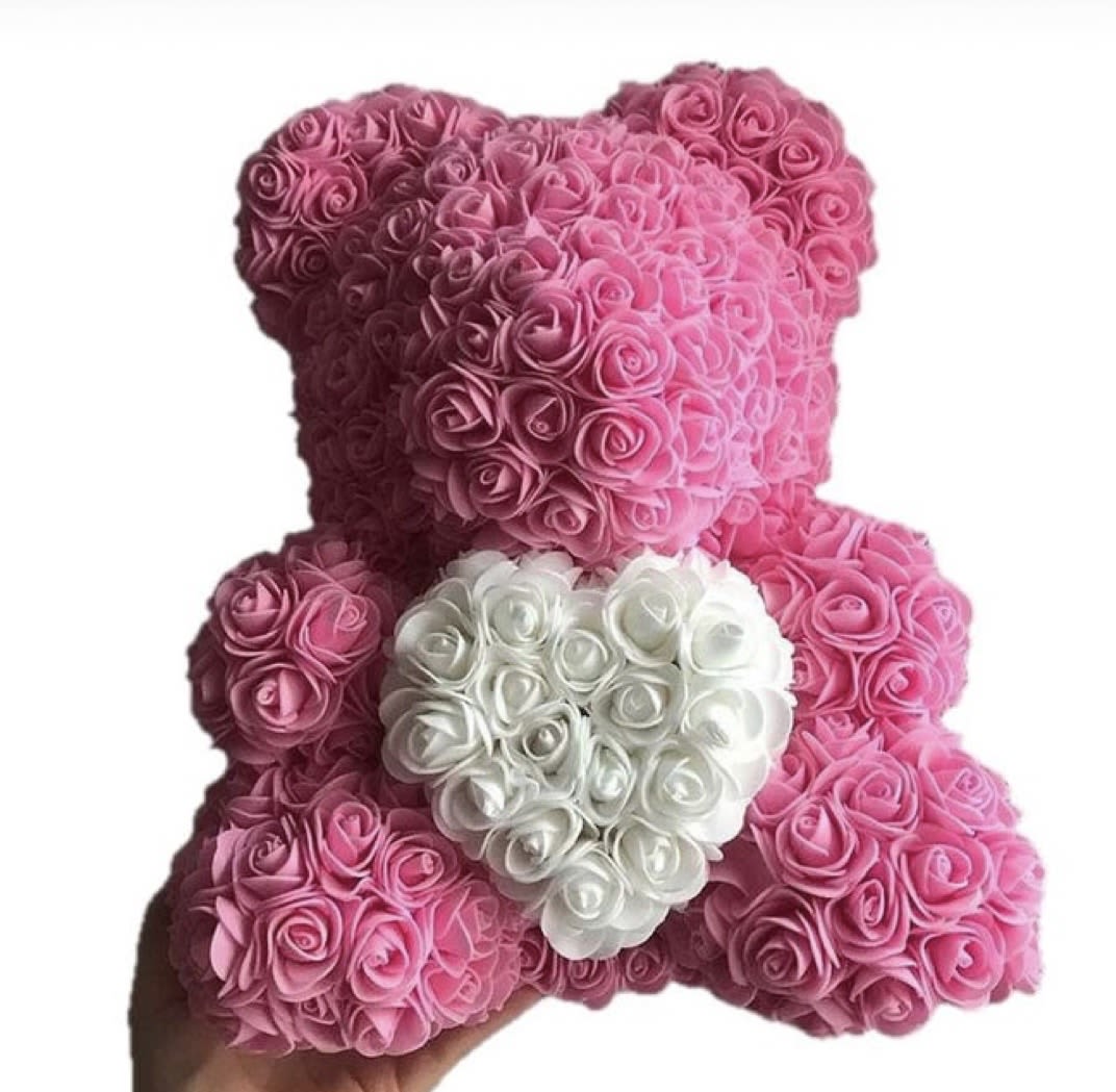 Pink rose teddy bear with a white heart on its chest