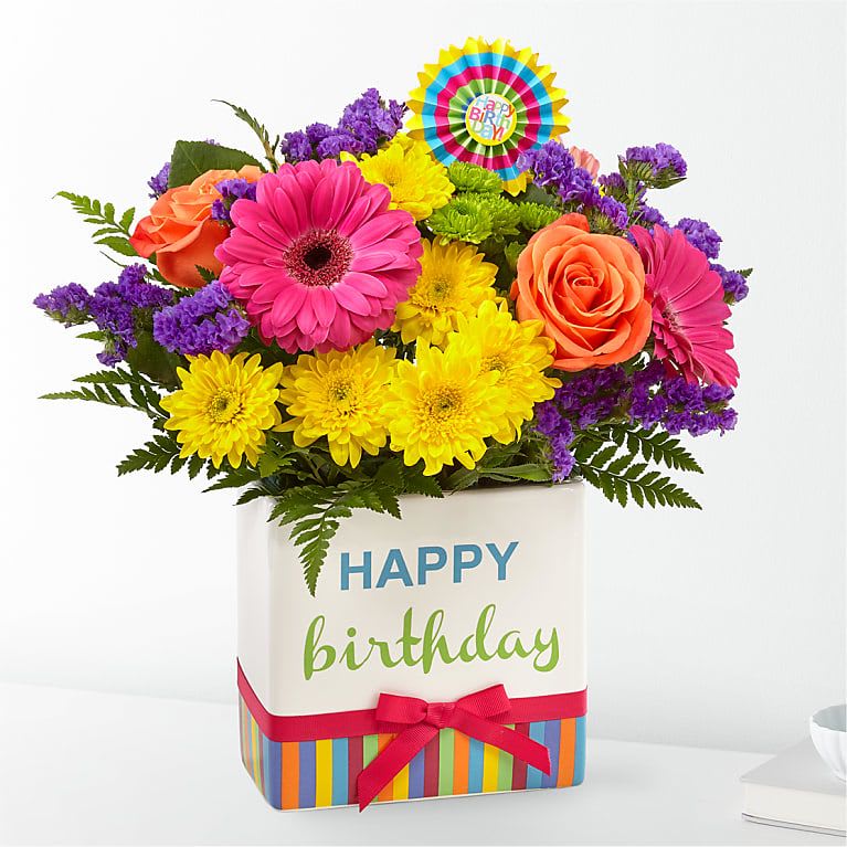 Bright mixed bouquet in a birthday gift box with a ribbon