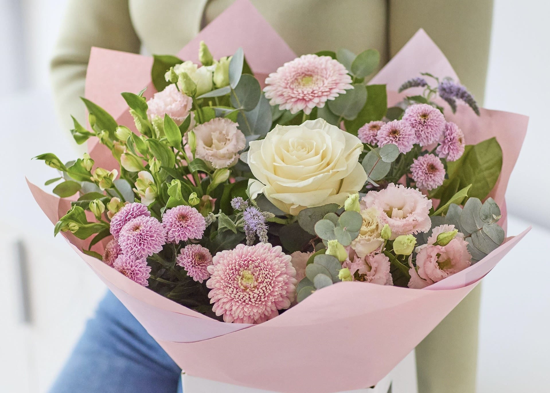 Pink and white mixed bouquet with a cream rose in pink paper