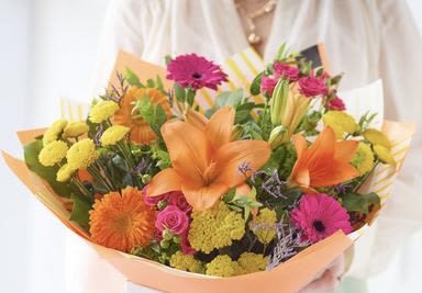 Bright mixed bouquet with orange lilies, pink gerberas, and yellow blooms