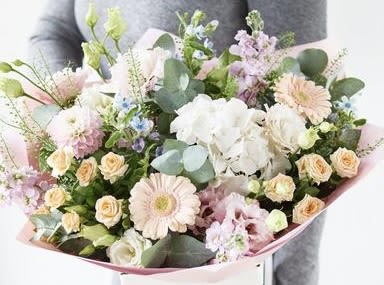 Pastel bouquet with white orchids, pink gerberas, and peach roses