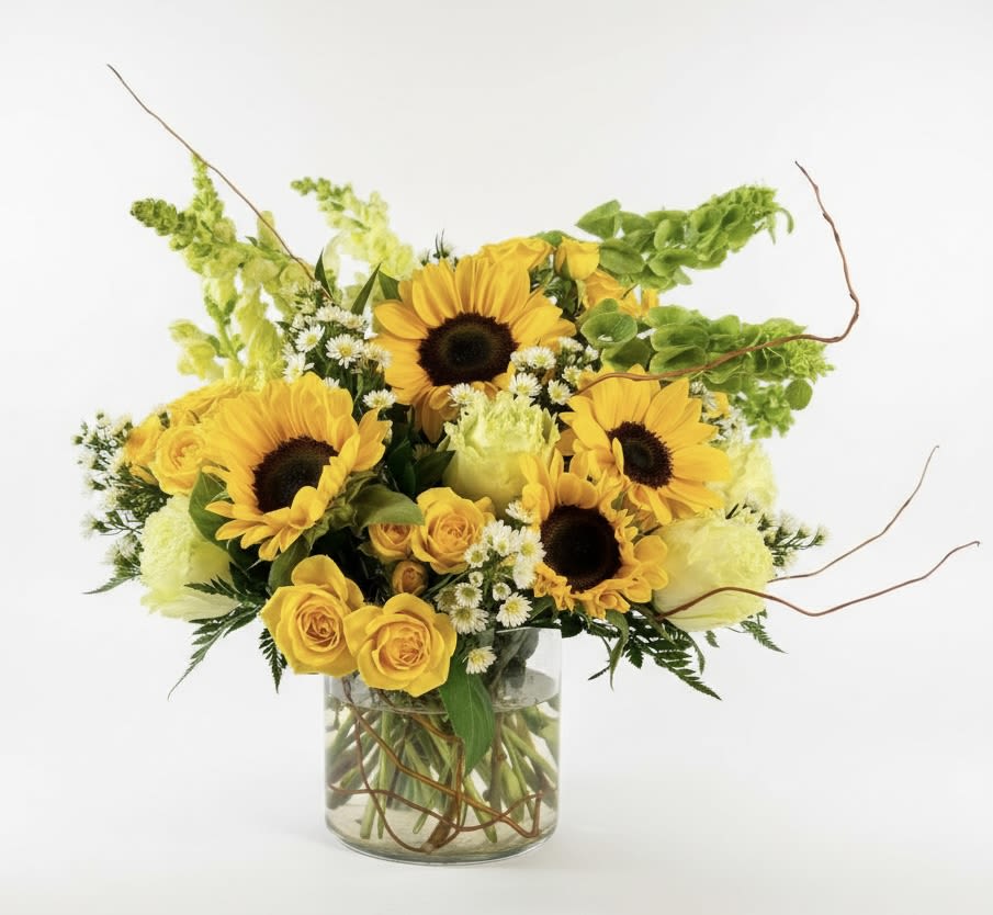 Sunflower and yellow rose bouquet in a clear glass vase