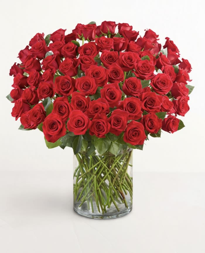 Large bouquet of red roses in a clear glass vase