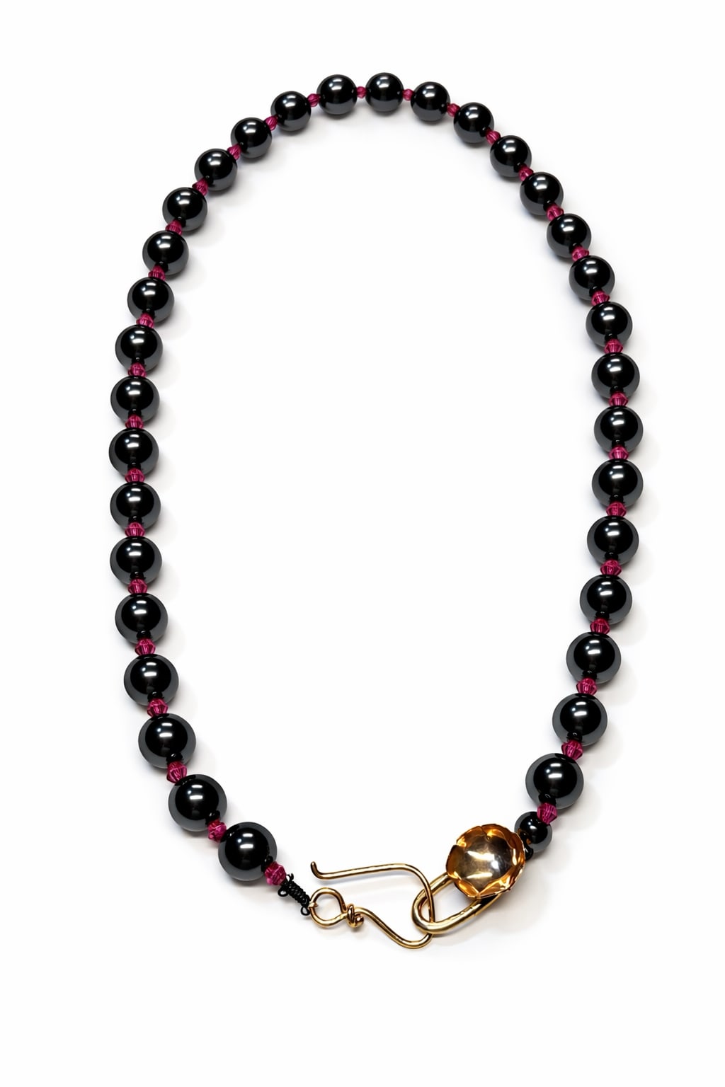 Black beaded necklace with a gold clasp on a white background