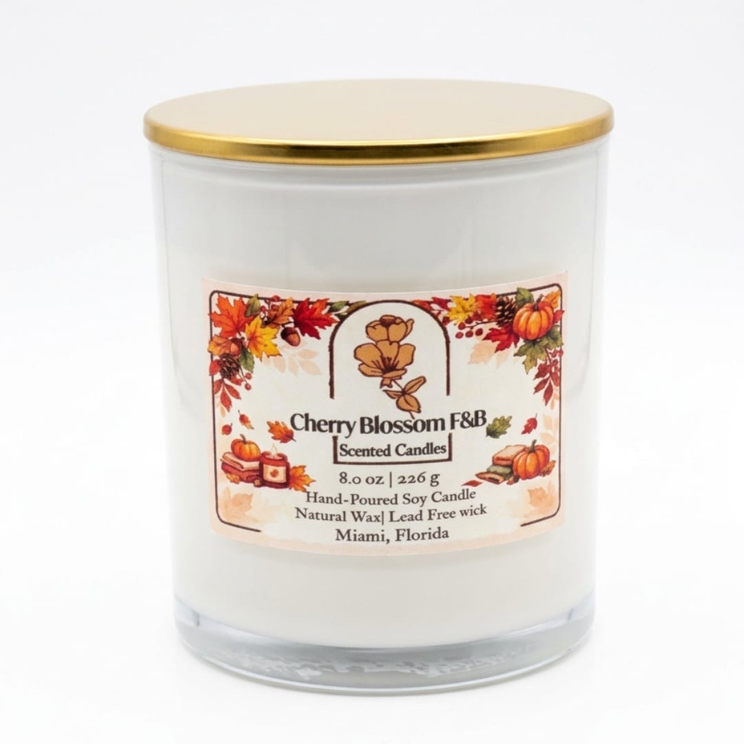 White scented candle in a glass jar with a gold lid