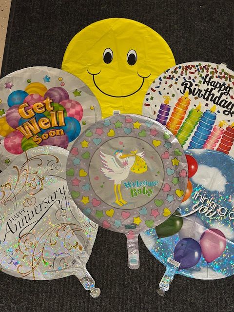 Assorted round foil balloons with birthday and baby messages