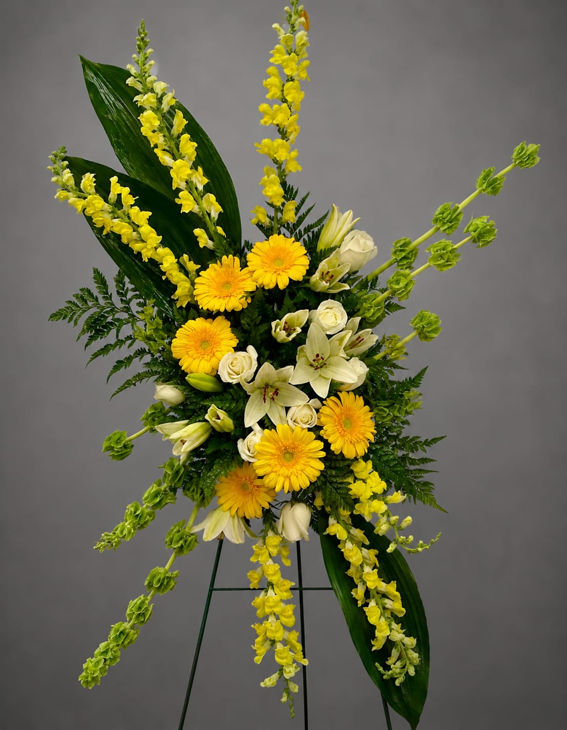 Yellow and white floral standing spray on an easel