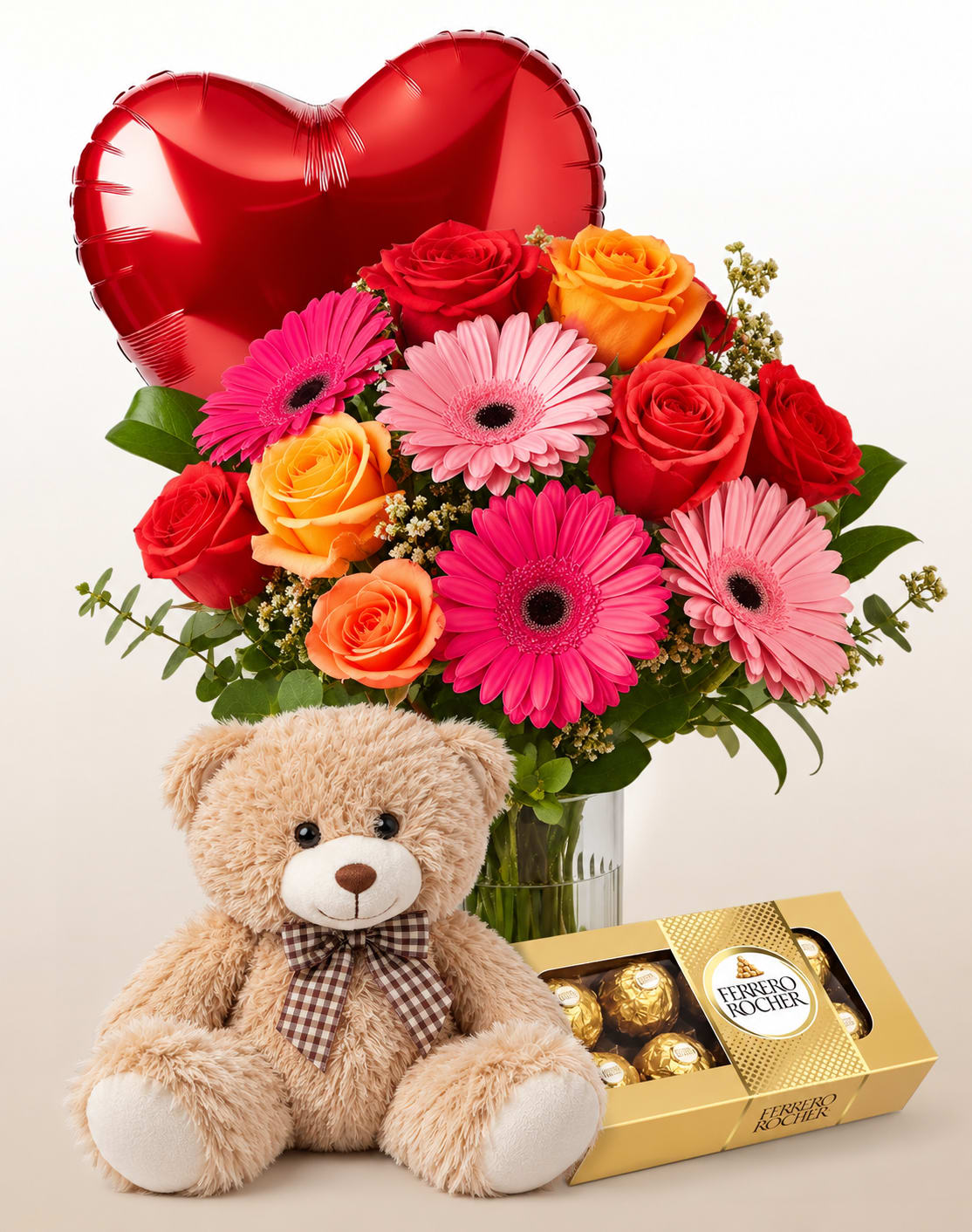 Bouquet of roses and gerbera daisies with a heart balloon, teddy bear, and chocolate box