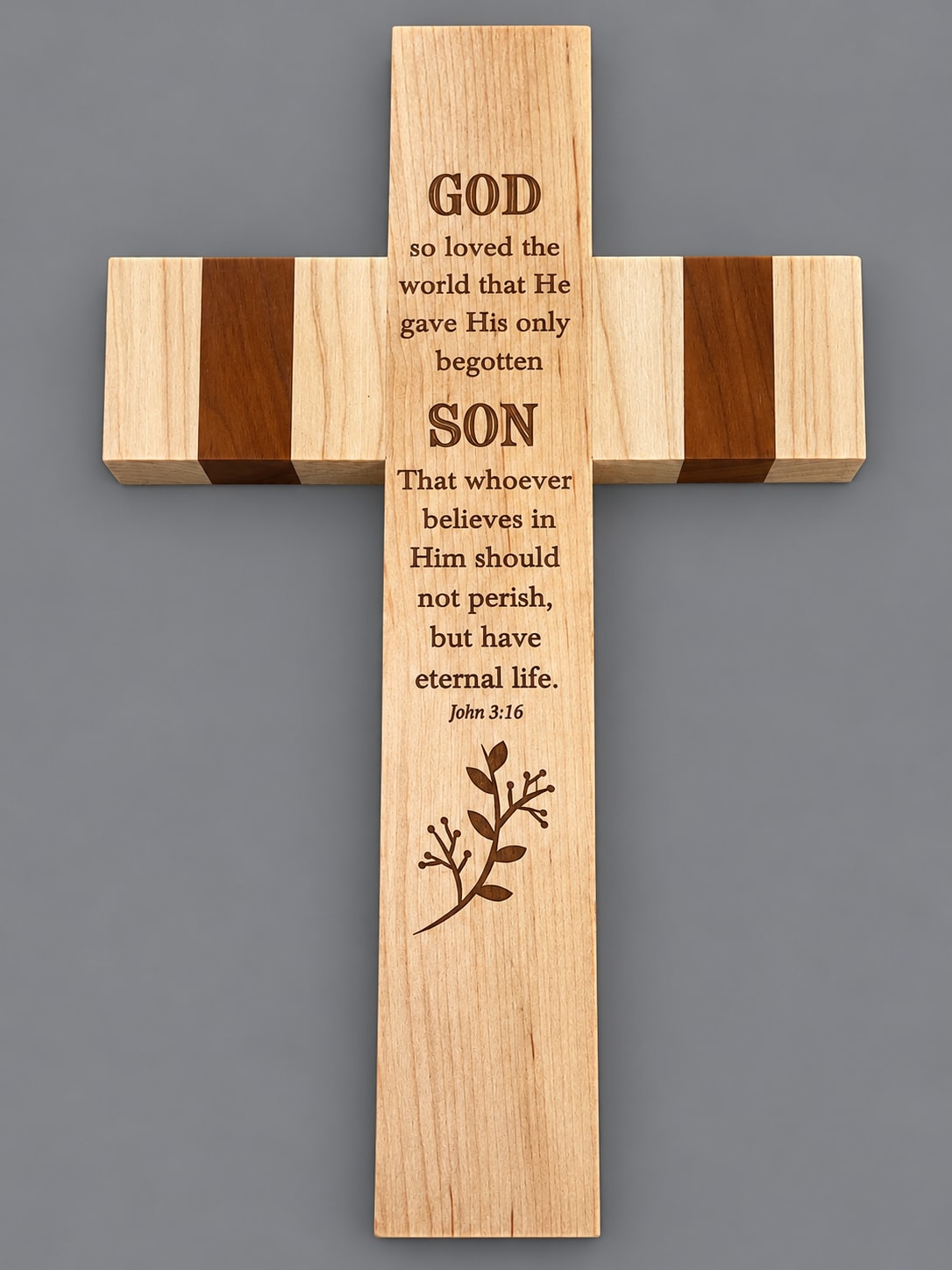 Wooden cross with engraved Bible verse on a gray background