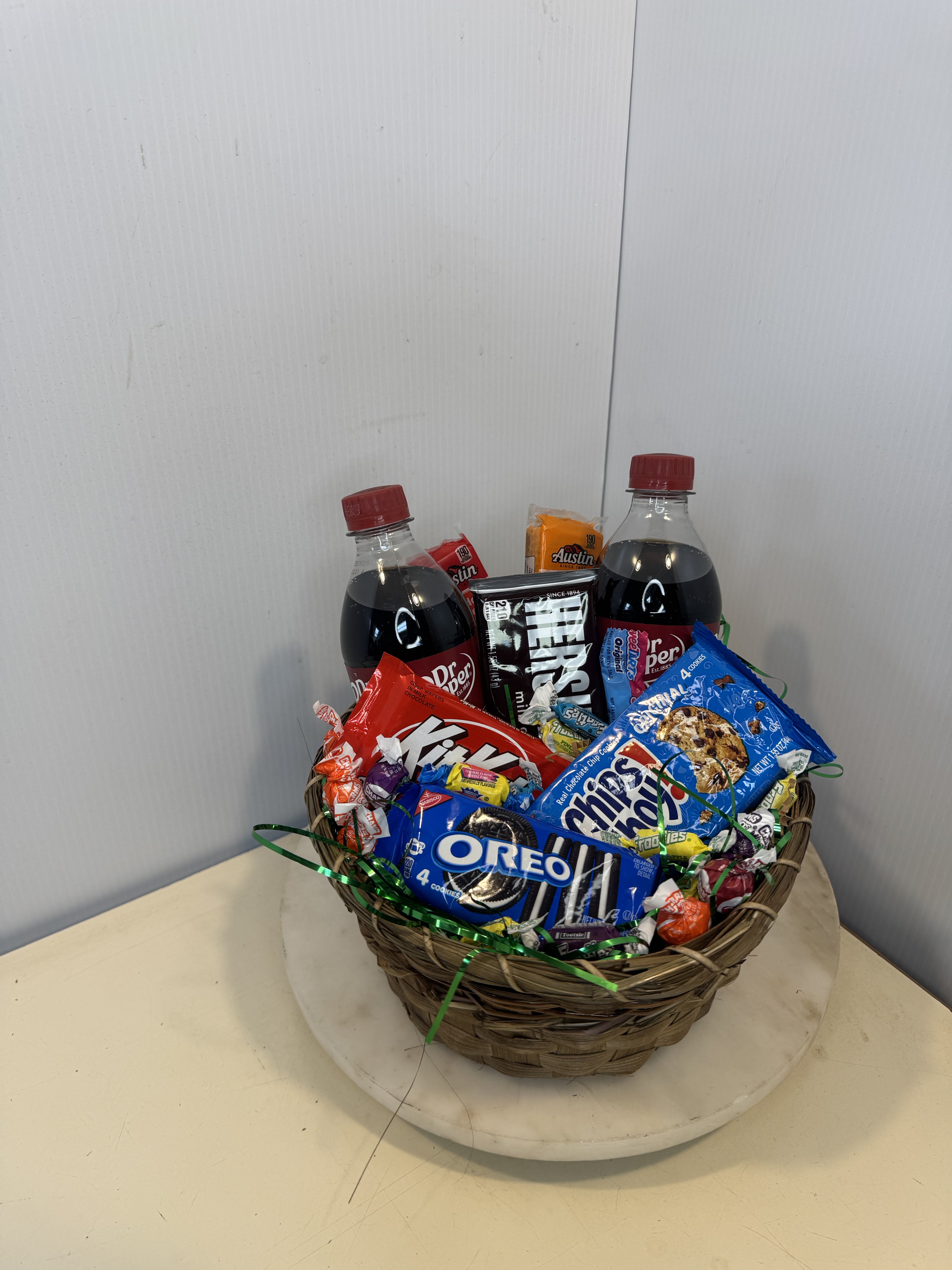 Basket of soda bottles and assorted candy and cookies