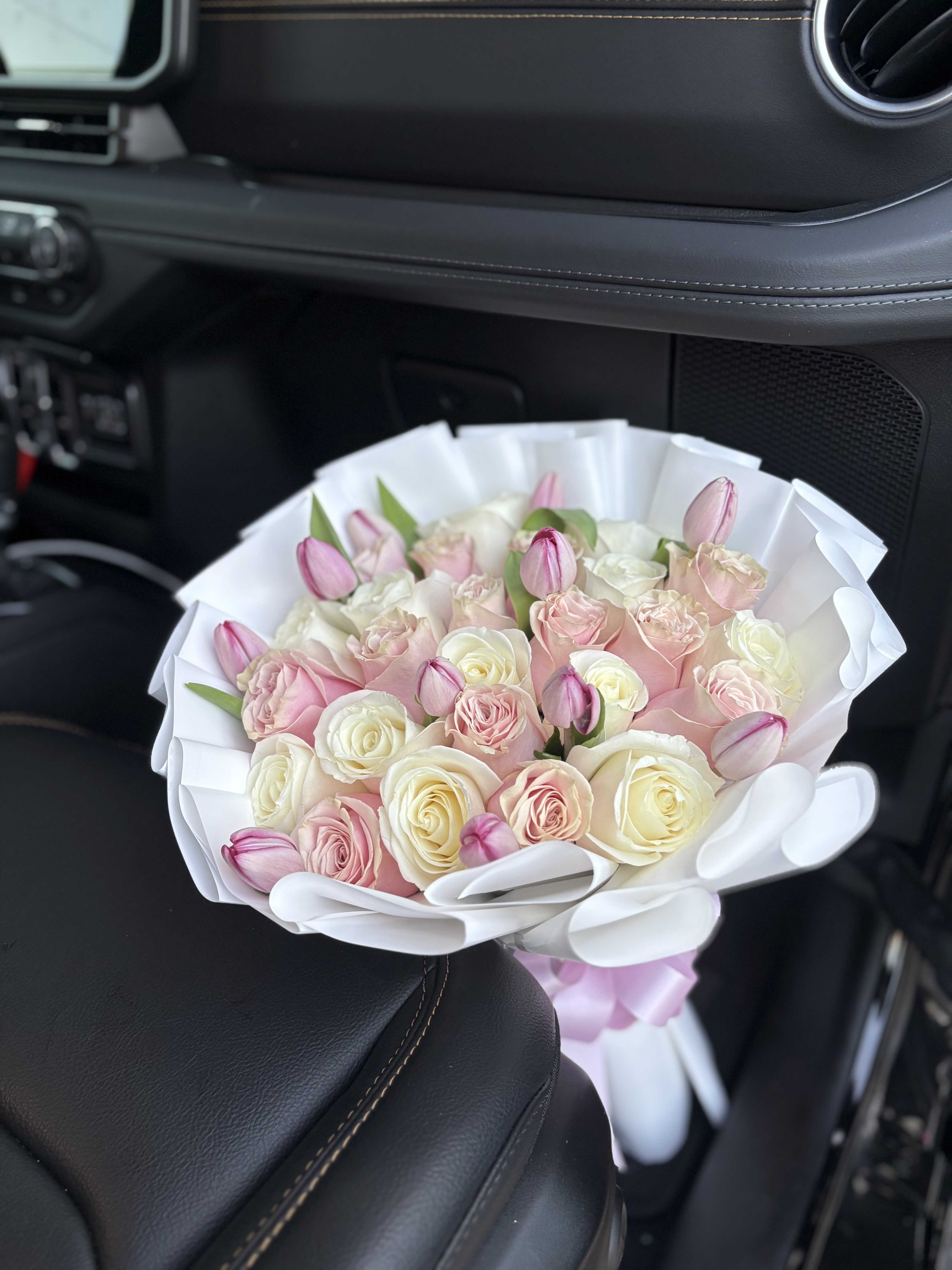 Tulip bouquet  - Pink and white roses with tulips in between them .