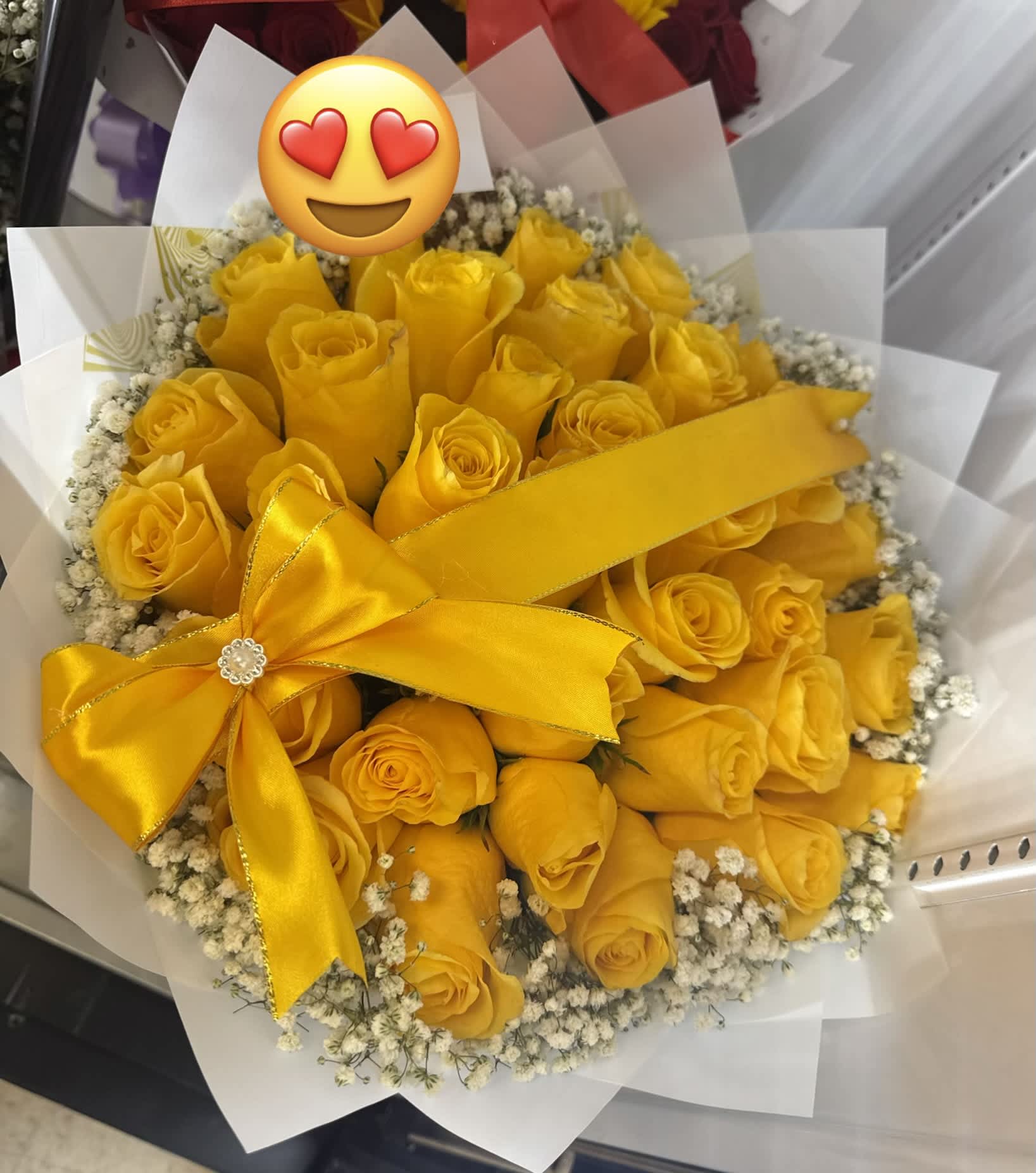 Bouquet of yellow roses with a satin ribbon and white filler flowers