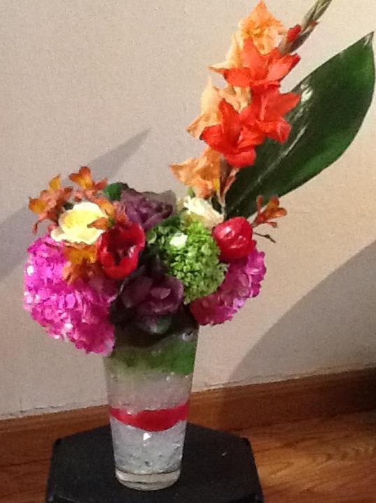 Colorful floral arrangement in a clear vase with orange and pink blooms