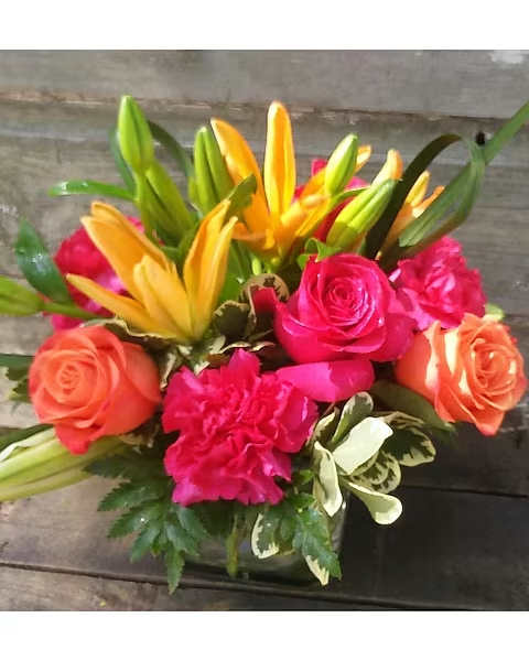 Bright bouquet of yellow lilies, pink roses, and orange roses