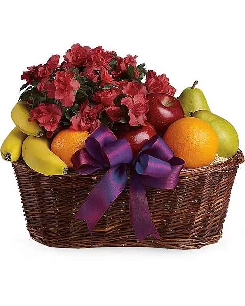 Basket of red flowers with assorted fruit and a purple ribbon