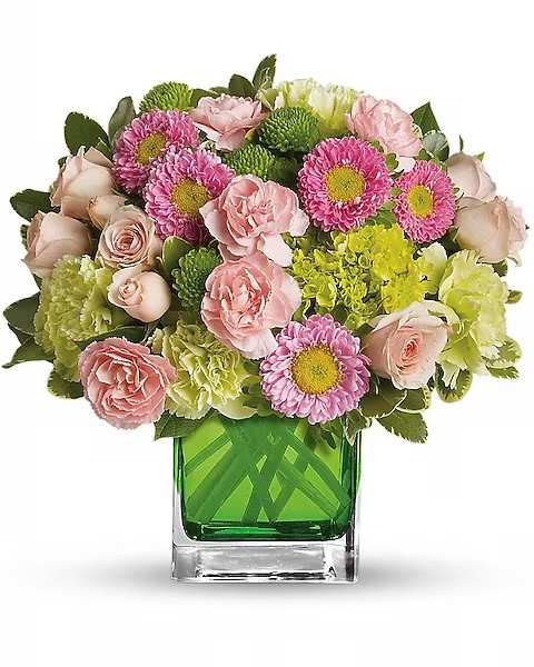 Pink and green mixed bouquet in a square glass vase