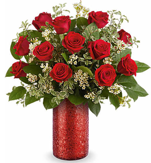 Red roses arranged in a red glitter vase