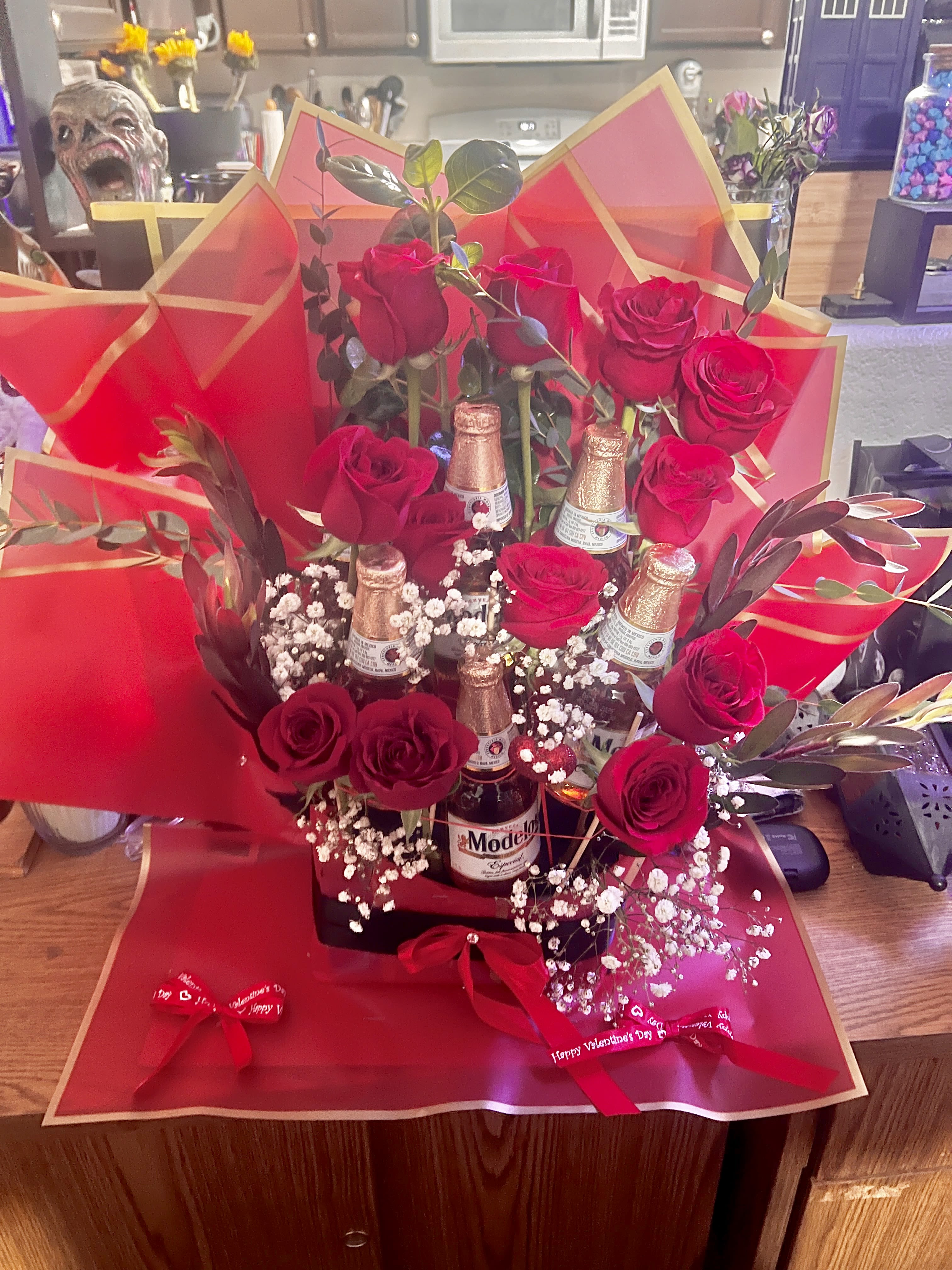 Bouquet of red roses with beer bottles and red wrapping